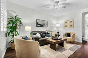 Living room with wood-type flooring and ceiling fan