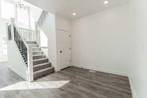 Foyer featuring hardwood / wood-style flooring and an inviting chandelier