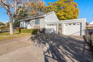 View of front facade featuring a front yard and a garage