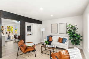 Living room with french doors and light hardwood / wood-style floors