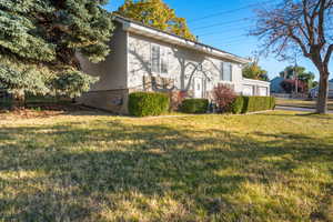 View of home's exterior with a yard