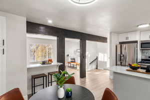 Dining area with light hardwood / wood-style flooring