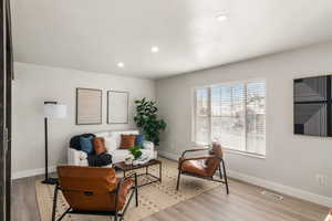 Living room with light hardwood / wood-style floors