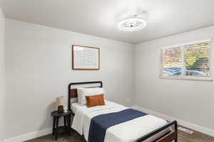 Bedroom with dark colored carpet