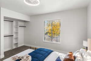 Carpeted bedroom featuring a closet