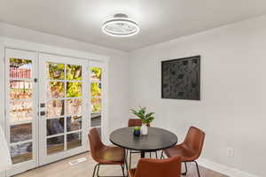 Dining area with light hardwood / wood-style flooring