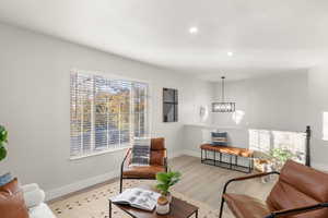 Living room featuring a chandelier and light hardwood / wood-style floors