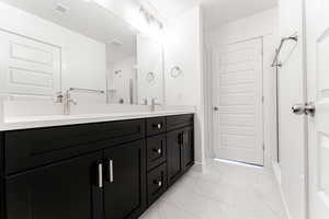 Bathroom featuring vanity and walk in shower