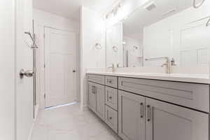 Bathroom featuring vanity and an enclosed shower