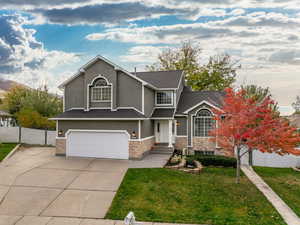 Front facade featuring a garage and a front lawn