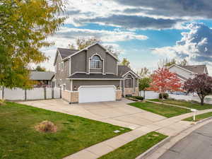 View of front facade with a front yard and a garage