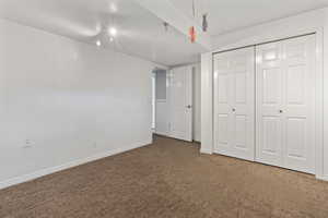 Unfurnished bedroom featuring a textured ceiling, carpet flooring, and a closet