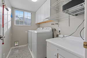 Laundry area with washer and dryer and cabinets