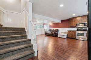 Interior space with dark wood-type flooring and stainless steel appliances