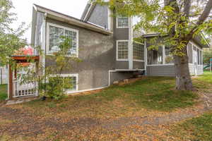 View of property exterior featuring a yard and a sunroom