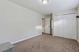 Unfurnished bedroom with a closet and carpet