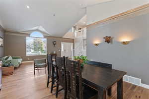 Dining space featuring lofted ceiling and light wood-type flooring