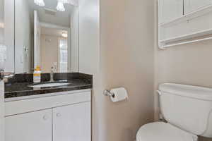 Bathroom featuring vanity and toilet