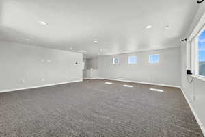 Empty room featuring carpet floors and a textured ceiling