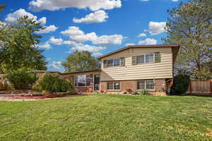 Tri-level home featuring a front lawn