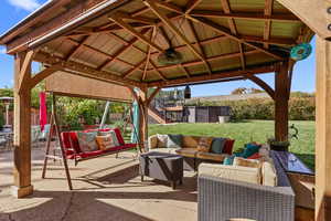 View of patio with a gazebo and an outdoor living space