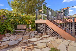 View of patio with a wooden deck