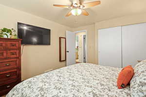 Bedroom with a closet and ceiling fan