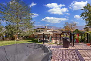 Wooden terrace featuring a yard, a gazebo, and a mountain view