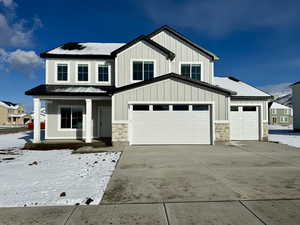 View of front of property with a porch and a garage