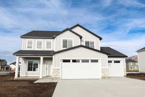 View of front facade featuring a garage