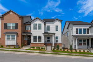 Townhome / multi-family property featuring brick siding