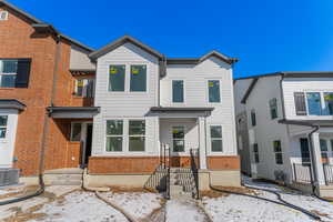 View of front of house with central AC