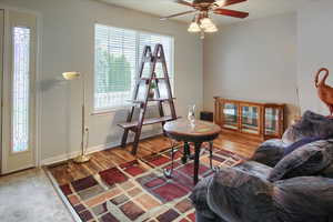 Living room featuring hardwood / wood-style floors and ceiling fan