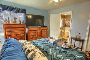 Bedroom with ceiling fan and ensuite bathroom