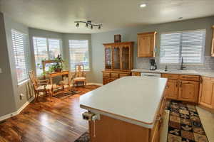 Kitchen featuring hardwood / wood-style flooring, a healthy amount of sunlight, and a center island