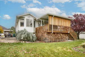 Exterior space with a yard and ceiling fan