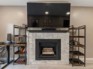 Details with hardwood / wood-style flooring and a fireplace