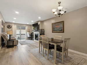 Dining space featuring an inviting chandelier and light wood-type flooring