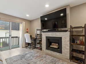 Living room with light hardwood / wood-style flooring and a fireplace