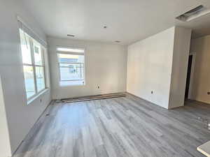 Spare room featuring light hardwood / wood-style floors and a baseboard radiator