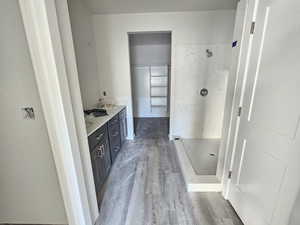 Bathroom featuring vanity, wood-type flooring, and independent shower and bath