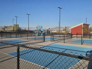 View of swimming pool featuring a mountain view and tennis court