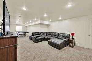 Living room featuring a textured ceiling and light colored carpet