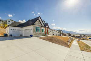 View of front of property with a mountain view and a garage