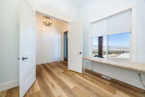 Interior space featuring light hardwood / wood-style floors, an inviting chandelier, and a mountain view