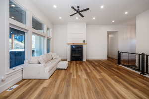 Living room featuring ceiling fan and light wood-type flooring