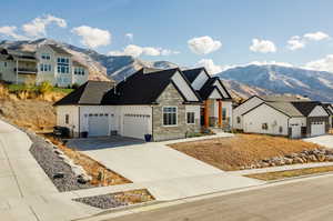 View of front facade with a mountain view and a garage