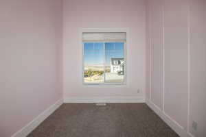 Unfurnished room featuring carpet