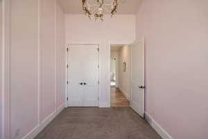 Interior space with a chandelier and carpet floors