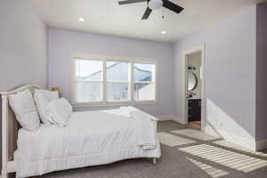 Bedroom with ensuite bath, sink, carpet, and ceiling fan